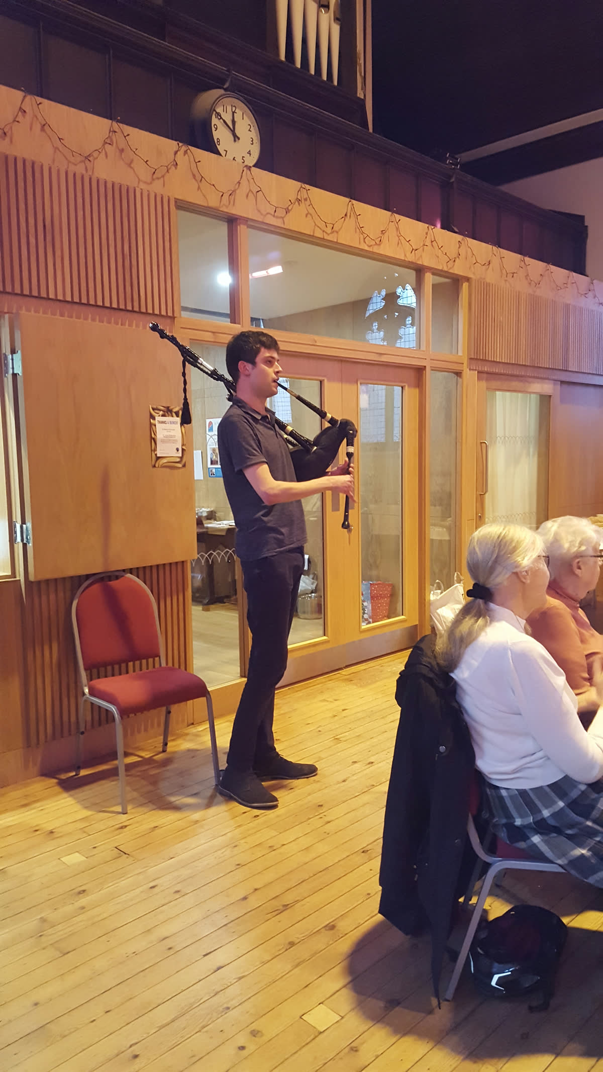 Calum playing the bagpipes at a Health All Round event
