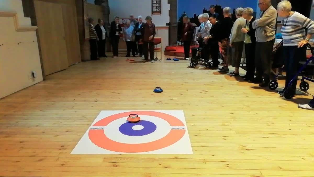 Health All Round members playing indoor curling